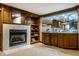 Basement wet bar with wood accents, a marble fireplace, and great lighting at 12613 Carrington Pl, Carmel, IN 46033