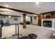 Large basement space with a fireplace, a workout area, and access to storage at 12613 Carrington Pl, Carmel, IN 46033