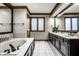 Spacious bathroom featuring a large soaking tub and double vanity with dark wood cabinets at 12613 Carrington Pl, Carmel, IN 46033