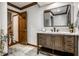 Bathroom vanity featuring a dark wood cabinet, white countertop, mirror, and tile flooring at 12613 Carrington Pl, Carmel, IN 46033