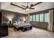 Spacious bedroom with neutral carpet, ceiling fan, and large windows at 12613 Carrington Pl, Carmel, IN 46033