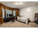 Bedroom with a window nook, neutral carpet, and a wooden accent wall at 12613 Carrington Pl, Carmel, IN 46033