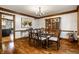 Dining room with hardwood floors, dining table and chairs, and a built-in china cabinet, exuding timeless elegance at 12613 Carrington Pl, Carmel, IN 46033