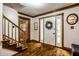 Foyer boasts hardwood floors and detailed wood trim, with a staircase adding architectural interest at 12613 Carrington Pl, Carmel, IN 46033