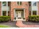 Inviting entryway with a brick path leading to a classic front door and manicured bushes at 12613 Carrington Pl, Carmel, IN 46033