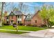 Charming two-story brick home featuring manicured landscaping and a lush green lawn at 12613 Carrington Pl, Carmel, IN 46033