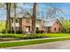 Charming two-story brick home featuring manicured landscaping and mature trees at 12613 Carrington Pl, Carmel, IN 46033