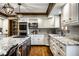 Modern kitchen with stainless appliances, granite counters, white cabinetry, and a central island at 12613 Carrington Pl, Carmel, IN 46033