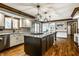 Stylish kitchen features granite countertops, stainless steel appliances, and a central island with a gas cooktop at 12613 Carrington Pl, Carmel, IN 46033