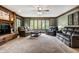 Cozy living room with fireplace, comfortable seating arrangement, and ample natural light creating an inviting atmosphere at 12613 Carrington Pl, Carmel, IN 46033