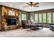 Inviting living room with fireplace, neutral tones, and large windows offering serene views of the outdoors at 12613 Carrington Pl, Carmel, IN 46033