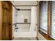Shower over tub with white subway tile, black fixtures, and a shower curtain at 12613 Carrington Pl, Carmel, IN 46033