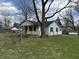 A view of the home's backyard, partially fenced with grass and large trees at 130 Hiawatha Dr, Noblesville, IN 46062