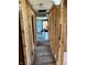 Framed hallway with exposed structure shows potential with a glimpse of bright rooms, good for renovation themes at 130 Hiawatha Dr, Noblesville, IN 46062