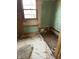 Image shows a room with damaged walls, window, and exposed wall cavity, showing the need for repair at 130 Hiawatha Dr, Noblesville, IN 46062