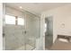 Elegant bathroom with tiled shower, built-in seat, and an open doorway to bedroom at 13349 Minden Dr, Fishers, IN 46037