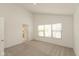 Bright bedroom with neutral carpeting, large window, and an ensuite bathroom at 13349 Minden Dr, Fishers, IN 46037