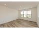 Simple bedroom featuring wood-look floors and large window providing natural light at 13349 Minden Dr, Fishers, IN 46037