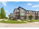 Attractive multi-level townhomes with brick and siding, complimented by landscaped lawns and a paved sidewalk at 13349 Minden Dr, Fishers, IN 46037
