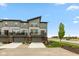 Modern townhome showcasing a contemporary design, private balconies, and well-manicured landscaping at 13349 Minden Dr, Fishers, IN 46037