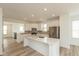 Bright kitchen with stainless appliances, white cabinets, quartz countertops, and hardwood-look flooring at 13349 Minden Dr, Fishers, IN 46037