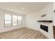 Bright living room features sleek wood flooring, modern fireplace, and a large window at 13349 Minden Dr, Fishers, IN 46037
