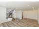 Spacious living room featuring hardwood-look floors, recessed lighting, and entry to staircase at 13349 Minden Dr, Fishers, IN 46037