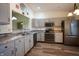Updated kitchen featuring stainless steel appliances, gray cabinets, wood floors and an open layout at 1366 Swan Dr, Franklin, IN 46131