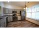 Modern kitchen featuring stainless steel appliances, gray cabinets, and a bright window over the sink at 1366 Swan Dr, Franklin, IN 46131