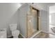 Bathroom featuring a tiled shower, toilet, and wooden-look flooring at 1528 E 300 N, Lebanon, IN 46052