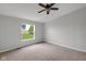 Carpeted bedroom with window views and ceiling fan at 1528 E 300 N, Lebanon, IN 46052
