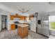This kitchen features wood cabinets, stainless steel appliances, an island and stylish flooring at 1528 E 300 N, Lebanon, IN 46052