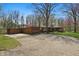 A cozy, one-story home with attached garage surrounded by mature trees, a gravel driveway and well-kept landscaping at 00 Oak Rd, Westfield, IN 46074