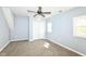 Bright bedroom with a ceiling fan, two windows, and a closet at 1814 New St, Indianapolis, IN 46203
