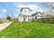 View of the exterior of a home with a two-story addition and a well maintained lawn at 1814 New St, Indianapolis, IN 46203