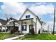This home boasts a covered porch, black trim, and newly landscaped yard at 1814 New St, Indianapolis, IN 46203
