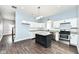 Modern kitchen features white cabinets, granite countertops, stainless appliances, and dark island at 1814 New St, Indianapolis, IN 46203
