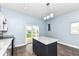 Eat-in kitchen has white cabinets, granite counters, stainless appliances, and access to the back yard at 1814 New St, Indianapolis, IN 46203