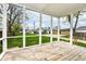 View of a screened-in porch with a wooden deck and backyard at 1814 New St, Indianapolis, IN 46203