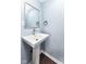 Updated powder room offers a modern pedestal sink, new fixtures, and warm wall color at 1814 New St, Indianapolis, IN 46203