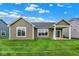Beautiful backyard showcasing green grass and the exterior of the home at 19123 River Jordan Pass, Westfield, IN 46074
