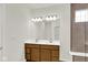 Bathroom featuring double vanity, large mirror with lighting, and glass shower with a built-in bench at 19123 River Jordan Pass, Westfield, IN 46074