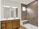Bright bathroom showcasing double vanity, large mirror, a glass shower with a built-in bench, and tile flooring at 19123 River Jordan Pass, Westfield, IN 46074