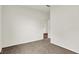 A carpeted room with view to hall and another room beyond at 19123 River Jordan Pass, Westfield, IN 46074