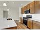 Modern kitchen with stainless steel appliances, gas range, and a kitchen island at 19123 River Jordan Pass, Westfield, IN 46074