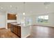 Open floorplan with kitchen island, stainless appliances, wood floors and lots of natural light at 19123 River Jordan Pass, Westfield, IN 46074