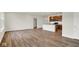 Spacious living room with hardwood floors, open floor plan, and adjacent kitchen with stainless appliances at 19123 River Jordan Pass, Westfield, IN 46074