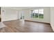 Bright living area with hardwood floors, large windows, and a sliding door for outdoor access at 19123 River Jordan Pass, Westfield, IN 46074