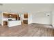 Open-concept living area featuring wood floors, natural light, and a seamless flow into the kitchen at 19123 River Jordan Pass, Westfield, IN 46074