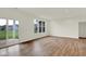 Bright and airy living area with hardwood floors, large windows, and sliding glass door to the patio at 19123 River Jordan Pass, Westfield, IN 46074